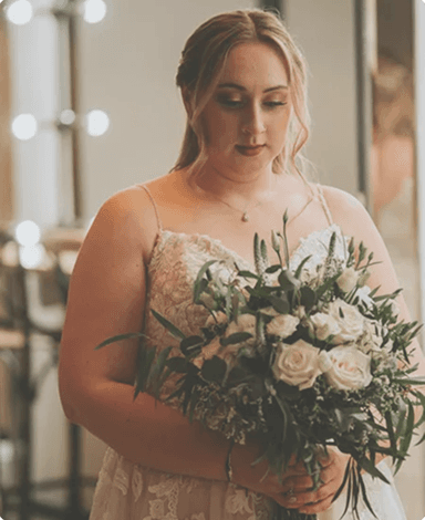 A beautiful bride holding a bouquet of white roses