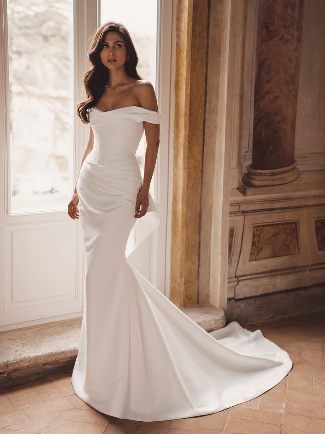 Trisha-S wedding dress by Blue by Enzoani This fitted satin bridal gown radiates classic glamour with... view 1