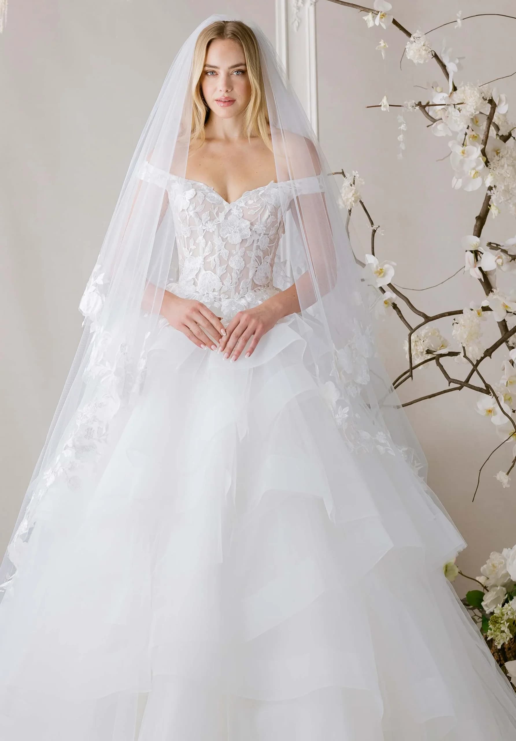 Kya- Morilee wedding dress by Morilee Ball gown wedding dress has a v-neckline on an off-the-shoul... view 1